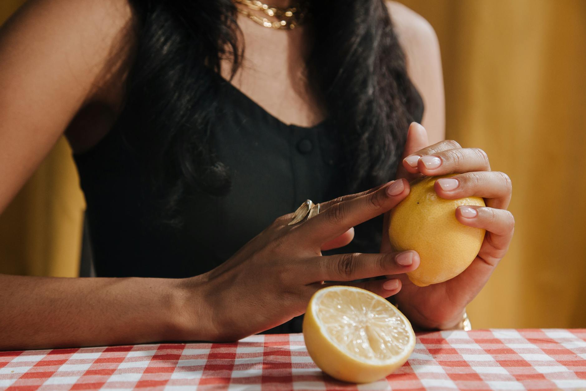 Bright yellow lemons arranged on a pastel green background, symbolizing the fresh approach to perimenopause pleasure