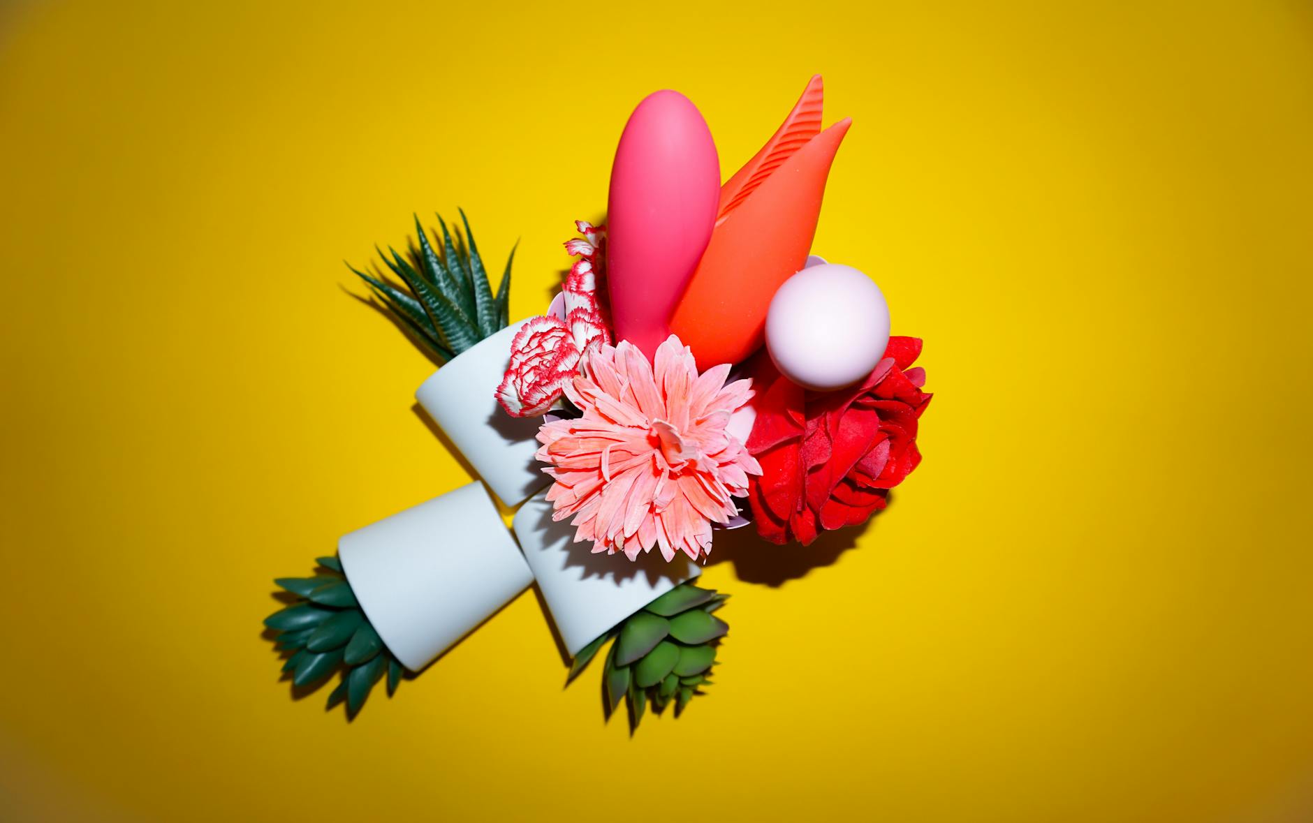 Close-up of colorful lemon clitoral vibrators and adult toys arranged together